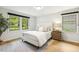 Cozy bedroom featuring neutral tones, two windows, and hardwood floors at 814 Ellynn Dr, Cary, NC 27511