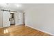 Bedroom with hardwood floors, white trim, sliding barn door to the bathroom, and natural light at 814 Ellynn Dr, Cary, NC 27511