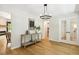 Entryway with hardwood floors, neutral walls, console table with decor, a modern chandelier, and french doors leading to dining room at 814 Ellynn Dr, Cary, NC 27511