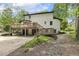 Rear view of the home shows the deck, garages, landscaping, and stairs at 814 Ellynn Dr, Cary, NC 27511