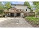 Elevated rear view of home with a large deck, garages, and stairs at 814 Ellynn Dr, Cary, NC 27511