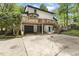 Rear exterior of home showing a large wooden deck and attached garages at 814 Ellynn Dr, Cary, NC 27511