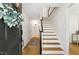 Bright and welcoming foyer with hardwood floors and a staircase leading to the upper level at 814 Ellynn Dr, Cary, NC 27511