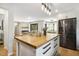 Open concept kitchen with butcher block island, connecting to a living area with a cozy fireplace at 814 Ellynn Dr, Cary, NC 27511