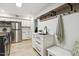 Well-equipped laundry room with stainless steel appliances, sink, counter space, and ample storage at 814 Ellynn Dr, Cary, NC 27511