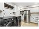 The laundry room has modern washer and dryer appliances, cabinetry, and marble countertops at 814 Ellynn Dr, Cary, NC 27511