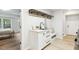 Bright laundry area with white cabinetry, sink, bench, and connection to the adjacent bedroom at 814 Ellynn Dr, Cary, NC 27511