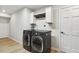 Convenient laundry area equipped with high-efficiency washer, dryer, and storage cabinets for organization at 814 Ellynn Dr, Cary, NC 27511