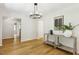 Living room with hardwood floors, neutral walls, and a modern chandelier, all complemented by a console table with decor at 814 Ellynn Dr, Cary, NC 27511