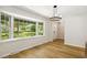 Bright living room with hardwood floors and a large window offering natural light and views of the landscaped front yard at 814 Ellynn Dr, Cary, NC 27511