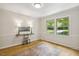 Office area features hardwood floors, wainscoting, and a large window overlooking the yard, creating a bright and airy workspace at 814 Ellynn Dr, Cary, NC 27511
