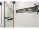 Modern shower with a glass door, white subway tile, and a recessed shelf, offering a clean and luxurious bathing experience at 814 Ellynn Dr, Cary, NC 27511
