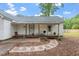 A large covered porch and walkway highlight the spacious backyard and exterior of home at 820 Southern St, Selma, NC 27576