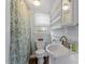Quaint bathroom with a leaf-themed shower curtain and white vanity at 820 Southern St, Selma, NC 27576