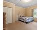 Light-filled bedroom with a full-sized bed, wood dresser, neutral walls, and neutral carpet at 820 Southern St, Selma, NC 27576