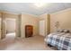 Bedroom with neutral carpet, light walls, a dresser and a full-sized bed. Features a view into the next room at 820 Southern St, Selma, NC 27576