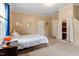 Cozy bedroom featuring light walls, neutral colored carpet, a queen-size bed and a window with a side table at 820 Southern St, Selma, NC 27576