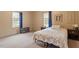 Bright bedroom with a floral bedspread, two bedside tables and natural light from a window with dark blue curtains at 820 Southern St, Selma, NC 27576