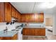 Classic kitchen featuring warm wood cabinets, white appliances, and modern flooring at 820 Southern St, Selma, NC 27576