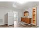 Bright kitchen featuring white fridge, wood cabinets, and eat-in dining space at 820 Southern St, Selma, NC 27576