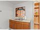 Close up of kitchen with light wood cabinets, stainless steel sink and open shelving unit at 820 Southern St, Selma, NC 27576