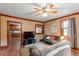 Inviting living room showcasing wood paneled walls, hardwood floors, furniture, and open view of kitchen at 820 Southern St, Selma, NC 27576