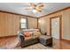 Well-lit living room featuring wood paneled walls, hardwood floors, comfortable furniture, and neutral colored walls at 820 Southern St, Selma, NC 27576
