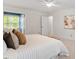 Bright bedroom featuring a ceiling fan, neutral paint, and a large bed with plush pillows at 8504 Boot Ct, Raleigh, NC 27615