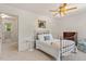 A well-lit bedroom featuring a ceiling fan, neutral decor and large window at 8504 Boot Ct, Raleigh, NC 27615