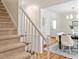 Inviting entryway with staircase and dining area with hardwood floors, creating a warm and elegant ambiance at 8504 Boot Ct, Raleigh, NC 27615