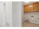 Dedicated laundry room with built-in cabinets and practical flooring at 8504 Boot Ct, Raleigh, NC 27615