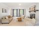 Cozy living room with fireplace, neutral decor, and lots of natural light at 8504 Boot Ct, Raleigh, NC 27615