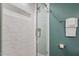 Modern bathroom features a glass shower with elegant white marble-style tile and a built-in niche at 8504 Boot Ct, Raleigh, NC 27615