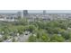 Scenic aerial view of a residential neighborhood with lush trees and the city skyline in the background at 905 Carroll St, Durham, NC 27701