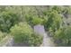 A bird's eye view of a house with a dark roof surrounded by an abundance of lush green trees at 905 Carroll St, Durham, NC 27701