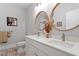 Bright bathroom featuring a double vanity with elegant round mirrors and modern fixtures at 905 Carroll St, Durham, NC 27701