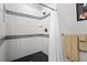 Modern bathroom shower features black and white tiling, and updated fixtures at 905 Carroll St, Durham, NC 27701
