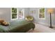 Well-lit bedroom with three windows and neutral carpet at 905 Carroll St, Durham, NC 27701