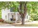 Charming two-story home with a welcoming front porch, featuring attractive landscaping and mature trees at 905 Carroll St, Durham, NC 27701