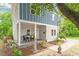 Inviting two-story home with a covered front porch, featuring elegant landscaping and a welcoming entrance at 905 Carroll St, Durham, NC 27701
