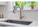 Close-up of a kitchen sink with a view to the outside at 905 Carroll St, Durham, NC 27701