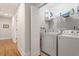 Clean laundry room with modern appliances and storage shelves at 905 Carroll St, Durham, NC 27701
