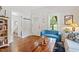 Comfortable living room with a blue sofa, hardwood floors and a doorway to the bedroom at 905 Carroll St, Durham, NC 27701