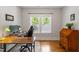 Office space featuring hardwood floors, a desk and a view of the trees at 905 Carroll St, Durham, NC 27701