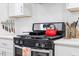 Kitchen stove and cooktop showing stainless steel appliances and white cabinets at 905 Carroll St, Durham, NC 27701