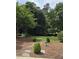 Expansive backyard with a white bench, stepping stones, and lush greenery, perfect for outdoor enjoyment at 9301 Brookton Ct, Raleigh, NC 27615