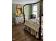 Bedroom showcasing a four-poster bed, bedside table, and hardwood floors at 9301 Brookton Ct, Raleigh, NC 27615