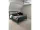 Cozy bedroom with iron bed frame and colorful quilt at 9301 Brookton Ct, Raleigh, NC 27615