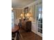 Elegant dining room with wooden floors and classic buffet with decorative mirror and lamps at 9301 Brookton Ct, Raleigh, NC 27615