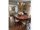 Charming dining room featuring a chandelier, hardwood floors, and open access to the living area at 9301 Brookton Ct, Raleigh, NC 27615